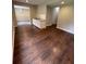 Cozy living room area featuring laminate flooring, neutral walls, and seamless flow to other spaces at 1951 Bergerac Sw Ct, Marietta, GA 30008