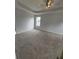 Main bedroom with a tray ceiling, ceiling fan, and carpeted floor at 1951 Bergerac Sw Ct, Marietta, GA 30008