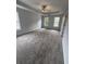 Spacious main bedroom featuring a tray ceiling, fan, carpeted floor and windows at 1951 Bergerac Sw Ct, Marietta, GA 30008