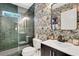 Chic bathroom boasts striking wallpaper, modern fixtures, and a glass-enclosed shower at 47 Roseclair Se Dr, Atlanta, GA 30317