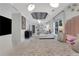 Bright primary bedroom with patterned ceiling, bed with cushioned headboard, and seating area at 47 Roseclair Se Dr, Atlanta, GA 30317