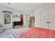Bright bedroom with a queen bed, a window, and a dark dresser and two double door closets at 47 Roseclair Se Dr, Atlanta, GA 30317