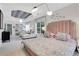 Bright primary bedroom with patterned ceiling, bed with cushioned headboard, and sitting area at 47 Roseclair Se Dr, Atlanta, GA 30317