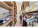 Custom walk-in closet with wooden shelves and racks providing ample storage space for clothes and accessories at 47 Roseclair Se Dr, Atlanta, GA 30317