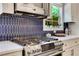 Updated kitchen showcasing blue backsplash tiles and a stainless steel stove at 47 Roseclair Se Dr, Atlanta, GA 30317