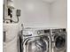 Modern laundry room featuring a new LG washer and dryer set with white walls and water tank at 47 Roseclair Se Dr, Atlanta, GA 30317