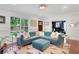 Inviting living room with blue sectional, decorative accents, and hardwood floors at 47 Roseclair Se Dr, Atlanta, GA 30317