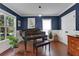 Charming music room with blue walls, large windows, hardwood floors, and a grand piano at 47 Roseclair Se Dr, Atlanta, GA 30317