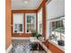 Sunroom with orange walls, geometric tile flooring, natural light from three windows, and a small table at 47 Roseclair Se Dr, Atlanta, GA 30317