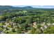 Picturesque aerial shot displaying a lush community nestled among mature trees, complemented by distant mountain views at 5925 Water Mark Dr, Cumming, GA 30040