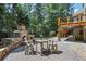 Backyard patio with stone fireplace and seating area, perfect for outdoor gatherings and relaxation at 5925 Water Mark Dr, Cumming, GA 30040