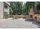 Backyard patio with stone fireplace and bar seating, ideal for outdoor entertaining at 5925 Water Mark Dr, Cumming, GA 30040