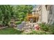 Charming backyard with a stone patio, outdoor kitchen and lush greenery at 5925 Water Mark Dr, Cumming, GA 30040