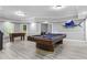 Basement featuring pool table, foosball table, wood laminate flooring and neutral paint at 5925 Water Mark Dr, Cumming, GA 30040