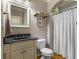 Cozy bathroom with hardwood floors, a framed mirror and a shower with curtain at 5925 Water Mark Dr, Cumming, GA 30040