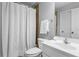 Bathroom featuring white shower curtain, toilet, sink, counter and white door at 5925 Water Mark Dr, Cumming, GA 30040