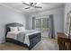 Well-lit bedroom with a classic bed frame, neutral carpet, and ample natural light at 5925 Water Mark Dr, Cumming, GA 30040