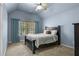 A bedroom with blue walls, carpet, window with blinds and curtains, and bed at 5925 Water Mark Dr, Cumming, GA 30040