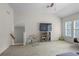 Bonus room with tv, shelving unit, and lots of open space at 5925 Water Mark Dr, Cumming, GA 30040