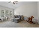 Bonus room with sectional, rocking horse, and multiple windows for natural light at 5925 Water Mark Dr, Cumming, GA 30040