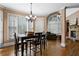 Bright dining room with wood floors, chandelier, and large windows offering natural light at 5925 Water Mark Dr, Cumming, GA 30040