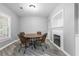 Cozy dining area features a round table, four chairs, stylish flooring, and a charming fireplace at 5925 Water Mark Dr, Cumming, GA 30040