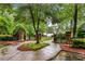 Stone pillars mark the entrance to this lushly landscaped property near a serene lake at 5925 Water Mark Dr, Cumming, GA 30040