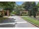 Stone entryway into the Lake Forest community with manicured landscaping at 5925 Water Mark Dr, Cumming, GA 30040