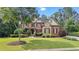 Charming two-story brick home with stone accents, well-manicured lawn, and mature trees at 5925 Water Mark Dr, Cumming, GA 30040
