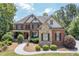 Charming two-story brick home with manicured landscaping and a welcoming front porch at 5925 Water Mark Dr, Cumming, GA 30040