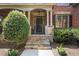 Elegant stone steps leading to a covered front porch and stylish front door at 5925 Water Mark Dr, Cumming, GA 30040