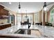 Bright kitchen featuring a view of the breakfast nook, dark wood cabinets, and granite countertops at 5925 Water Mark Dr, Cumming, GA 30040