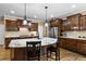 Kitchen featuring stainless steel appliances, a large island, hardwood floors, dark wood cabinets, and bar stool seating at 5925 Water Mark Dr, Cumming, GA 30040