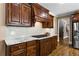 Modern kitchen with granite countertops, hardwood floors, dark wood cabinets, and an island cooktop at 5925 Water Mark Dr, Cumming, GA 30040