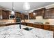 Modern kitchen with granite countertops, hardwood floors, dark wood cabinets and stainless steel appliances at 5925 Water Mark Dr, Cumming, GA 30040