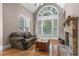 Comfortable living room with a stone fireplace and expansive window at 5925 Water Mark Dr, Cumming, GA 30040