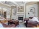 Cozy living room featuring hardwood floors, fireplace, custom built-ins and an area rug at 5925 Water Mark Dr, Cumming, GA 30040