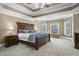 Spacious main bedroom with large bed, tray ceilings, and bay window at 5925 Water Mark Dr, Cumming, GA 30040