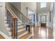 Elegant staircase with wood treads, wrought iron railings, and natural light at 5925 Water Mark Dr, Cumming, GA 30040