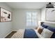 A virtually staged bedroom featuring stylish decor, neutral walls, and a window at 6185 Marbut Farms, Lithonia, GA 30058