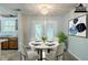 Bright dining area featuring modern lighting, dining table set, and doors providing natural light at 6185 Marbut Farms, Lithonia, GA 30058