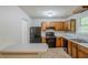 Functional kitchen with wooden cabinets and black appliances offering practical cooking space at 6185 Marbut Farms, Lithonia, GA 30058