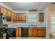 Well-lit kitchen features wooden cabinets, modern appliances, and a functional layout at 6185 Marbut Farms, Lithonia, GA 30058