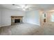 Spacious living room showcasing a stone fireplace and an open view into the kitchen area at 6185 Marbut Farms, Lithonia, GA 30058