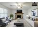 Staged living room with stone fireplace, ceiling fan, and neutral-toned furniture at 6185 Marbut Farms, Lithonia, GA 30058