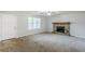 Cozy living room with stone fireplace, ceiling fan, and large window bringing in natural light at 6185 Marbut Farms, Lithonia, GA 30058