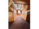 Attic space with sloped wood paneling, neutral carpet and a window at 1292 Lorenzo Sw Dr, Atlanta, GA 30310