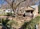 Quaint tan home with covered porch amid a yard with mature trees at 1292 Lorenzo Sw Dr, Atlanta, GA 30310