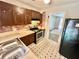 Cozy kitchen features brown cabinets, stainless steel stove, and checkered floors at 1292 Lorenzo Sw Dr, Atlanta, GA 30310