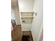 Compact laundry area with shelving, utility connections, and visible flooring at 1292 Lorenzo Sw Dr, Atlanta, GA 30310